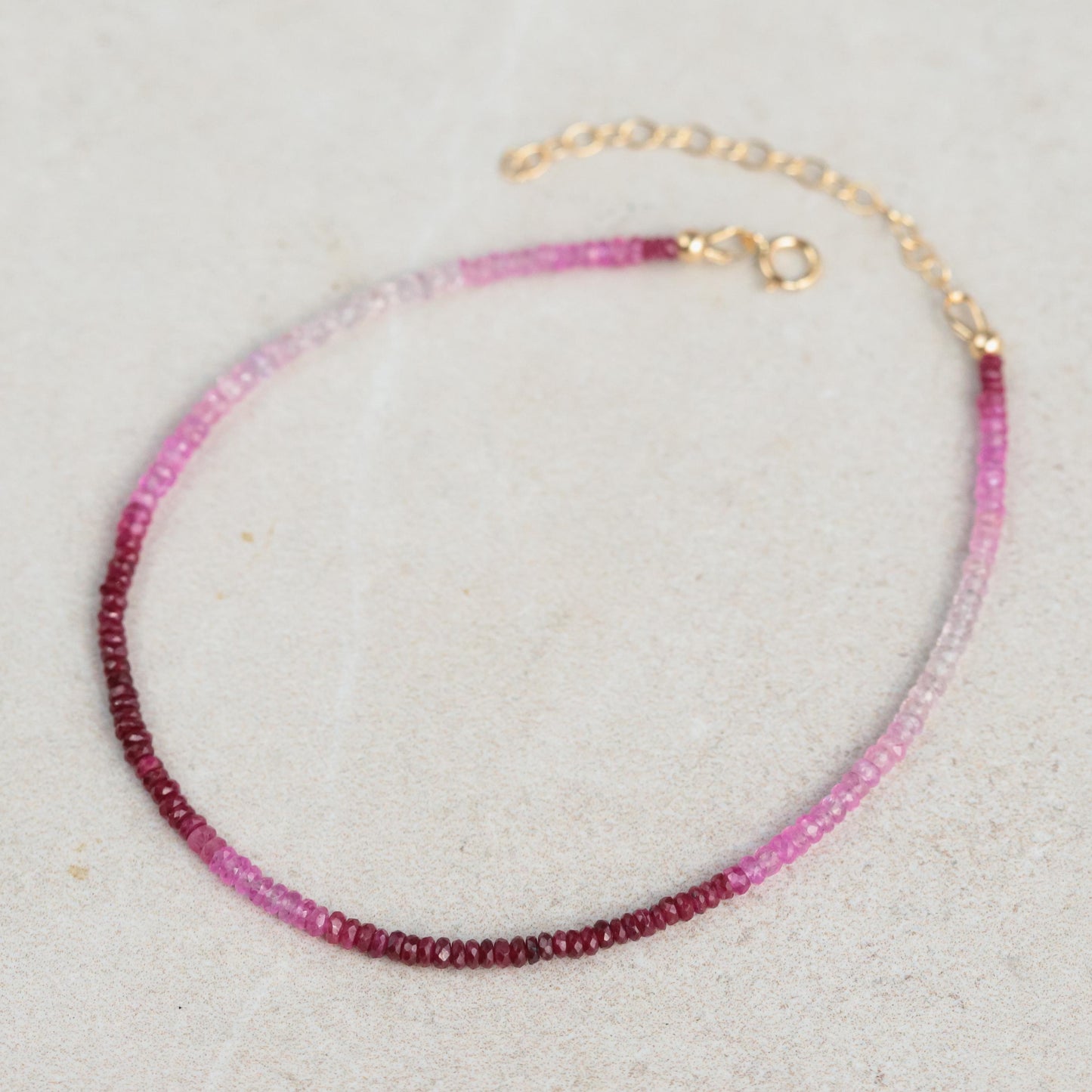 Raspberry Mist Ruby anklet with 14K gold chain from Earthly Abundance, featuring vibrant ruby beads and delicate design.