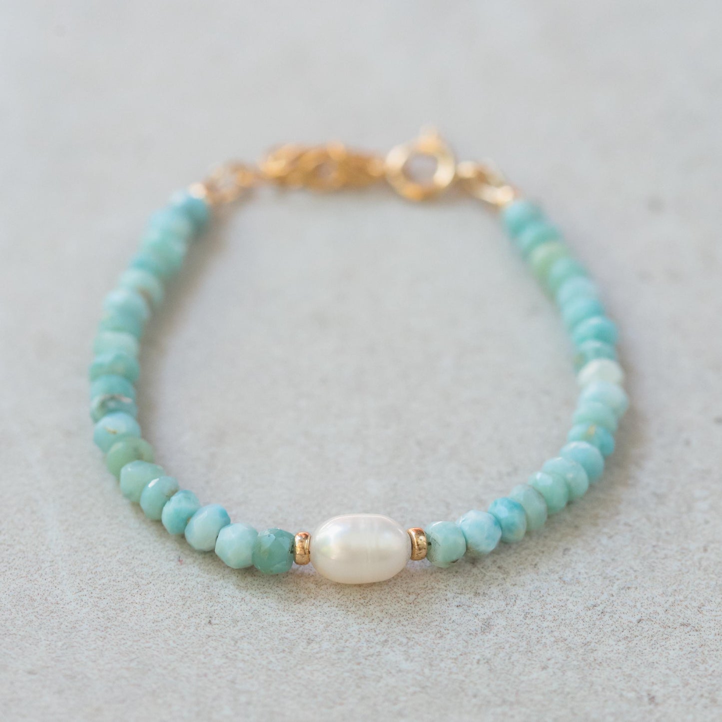 Soft ocean larimar and pearl bracelet from Earthly Abundance featuring delicate blue stones and elegant design.