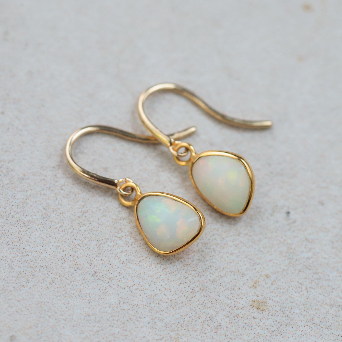 Ethiopian Opal Earrings in 14K gold with elegant, sparkling opal stones and delicate gold settings by Earthly Abundance.