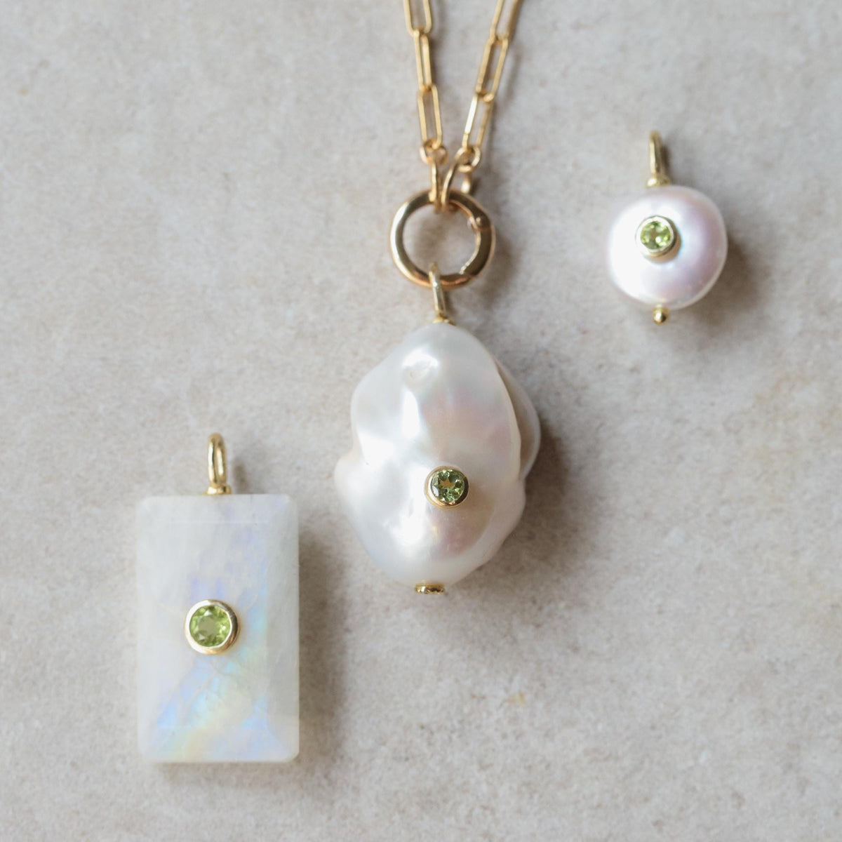 Earthly Abundance Solace Pearl Peridot Necklace featuring a pearl and peridot pendant on a delicate chain.