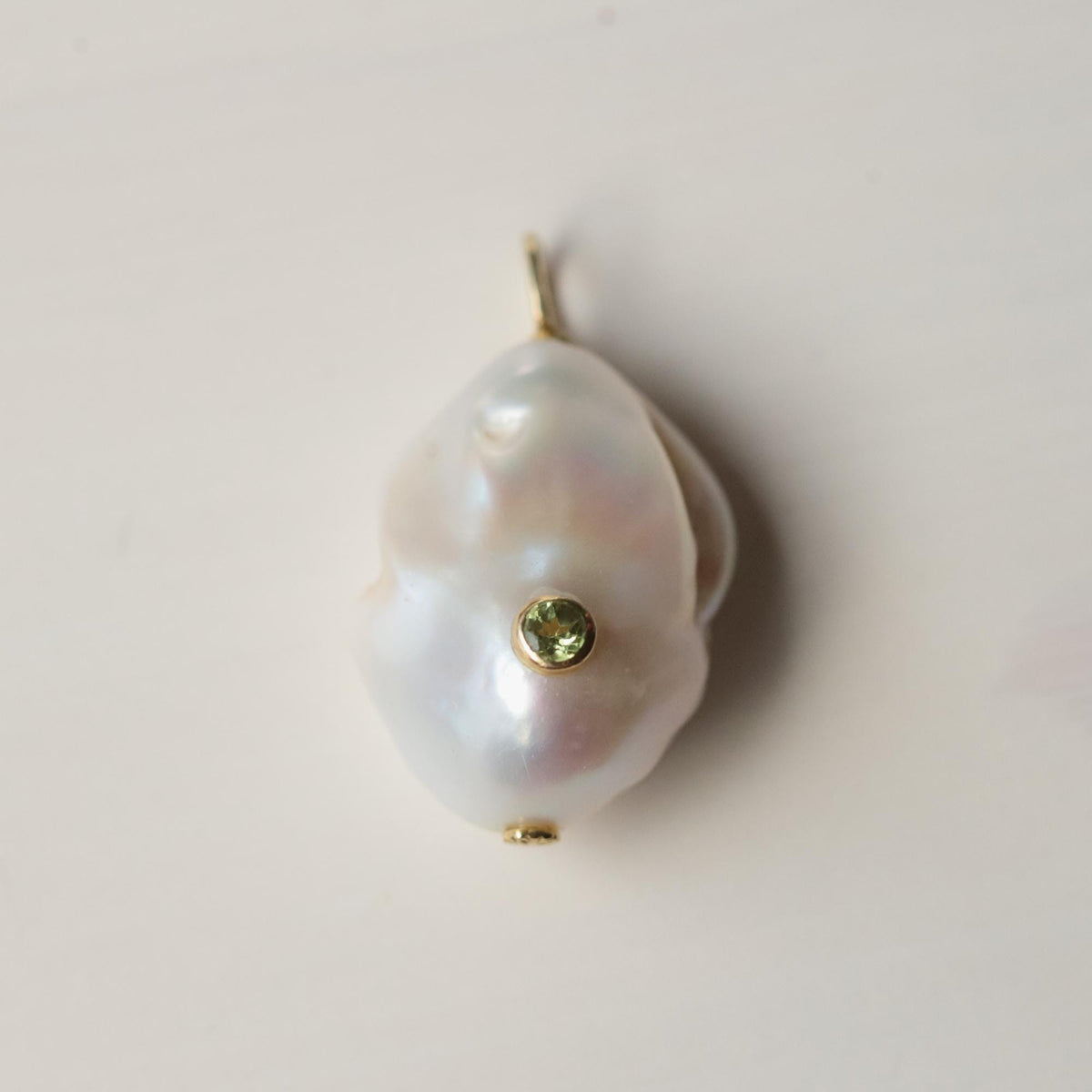 Lumen Baroque Pearl and Peridot necklace by Earthly Abundance featuring irregular pearls and vibrant green peridot gemstones.