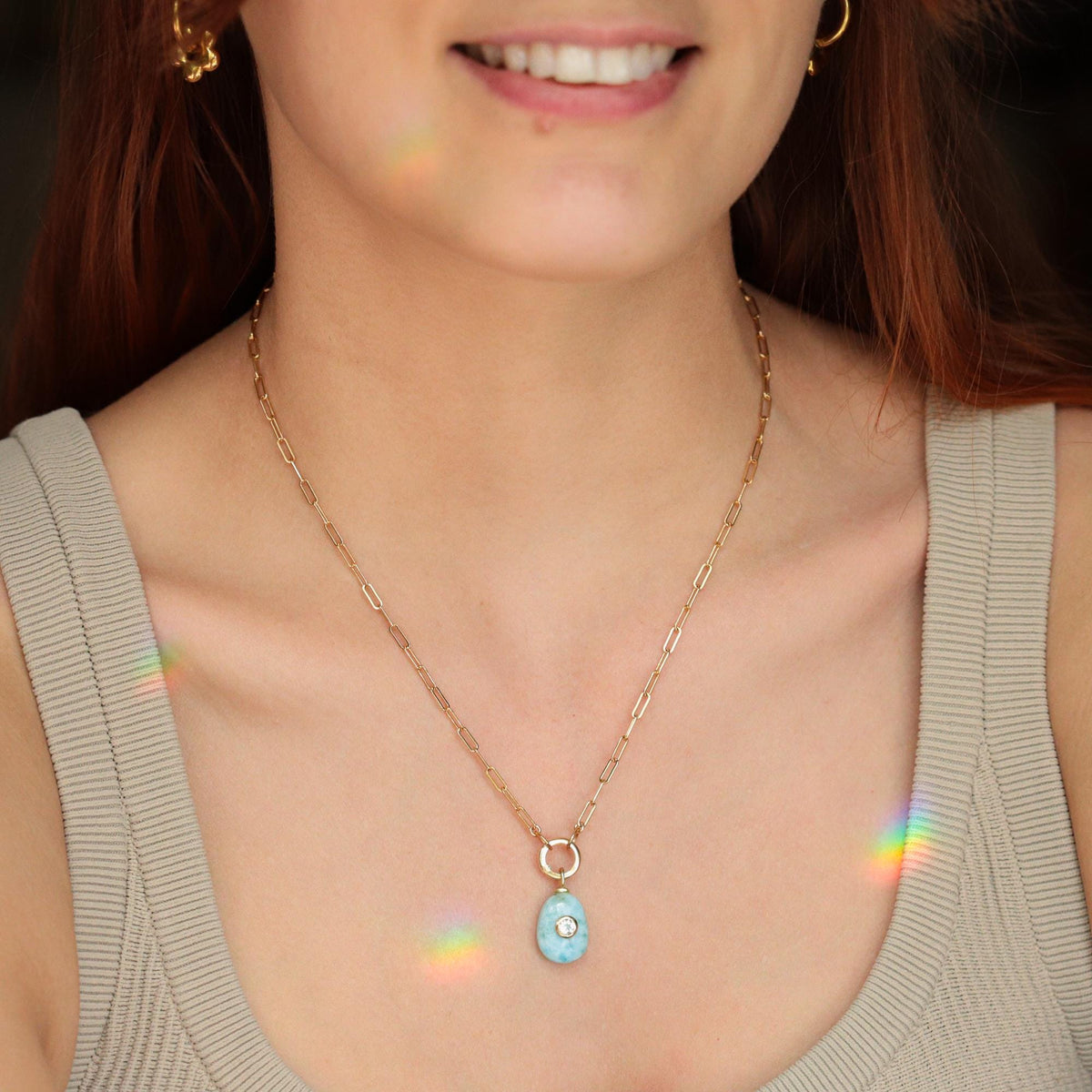 Larimar necklace with white topaz gemstones, featuring a vibrant blue gemstone pendant and sparkling accents, from Earthly Abundance.