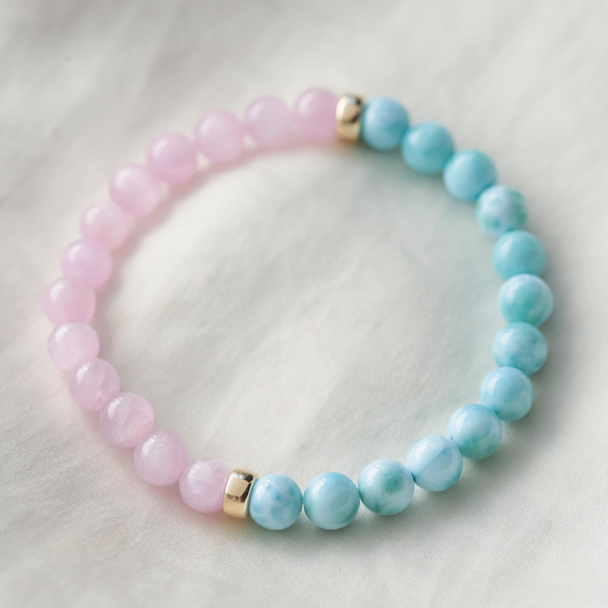 Ocean Calm Larimar and Kunzite bracelet featuring blue larimar and pink kunzite beads on a delicate silver chain.