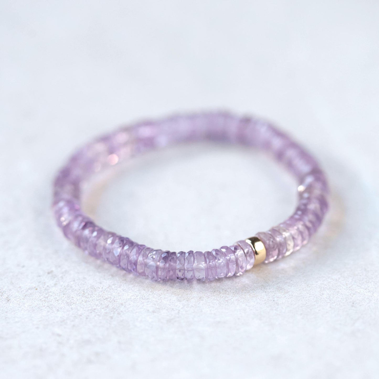 Ethereal pink amethyst heishi bracelet from Earthly Abundance featuring round pink purple gemstone beads on a stretch cord.