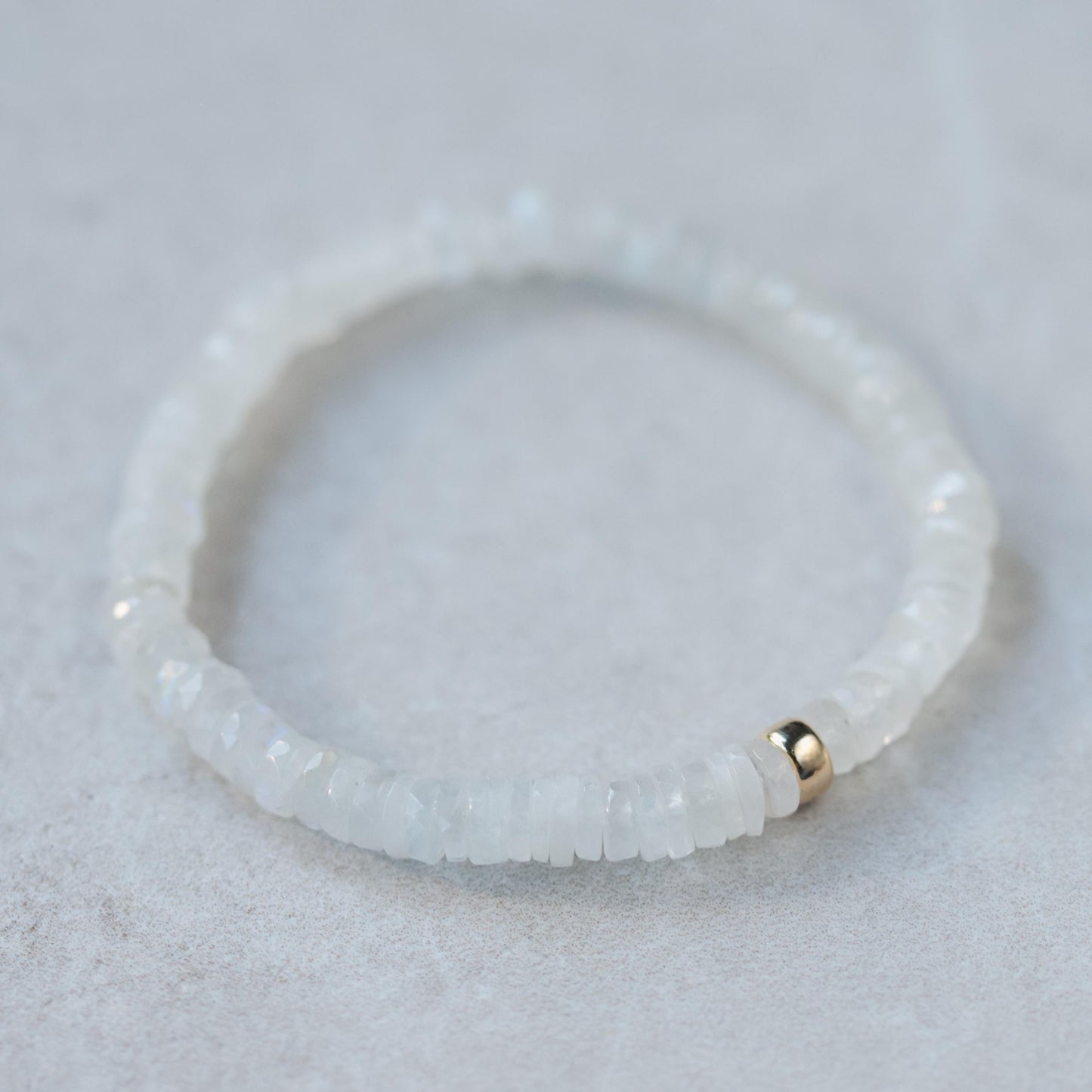 Rainbow Moonstone bracelet with celestial-themed beads from Earthly Abundance, featuring moon and star accents.