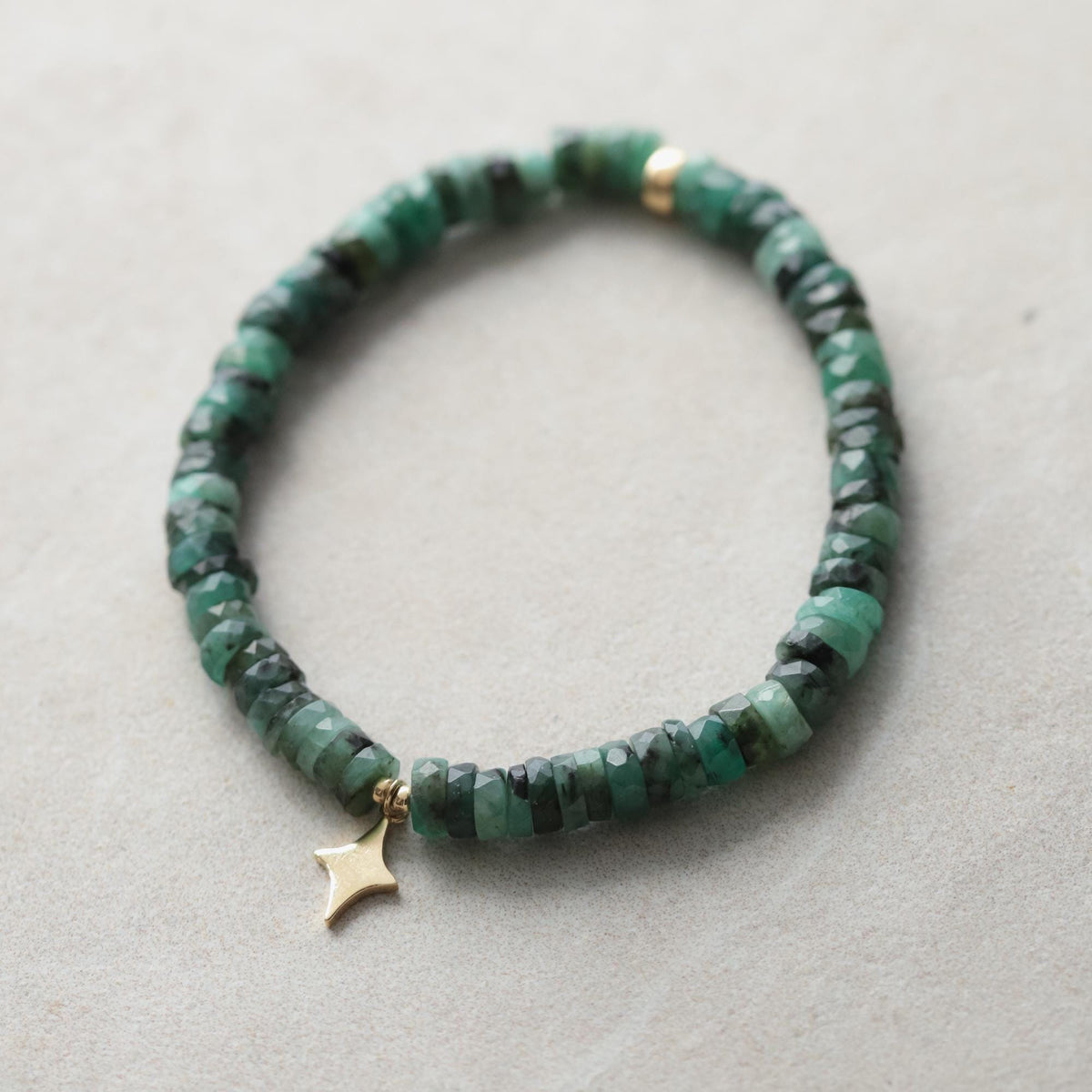 Emerald North Star Heishi bracelet with 14K gold accents from Earthly Abundance, featuring small green gemstone beads.