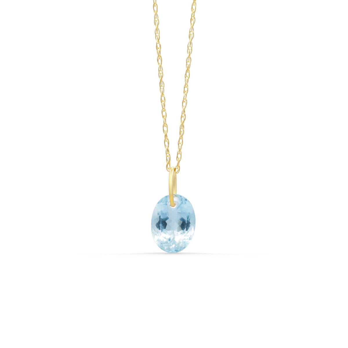 Solid gold aquamarine pendant featuring a vibrant blue gemstone, crafted by Earthly Abundance.