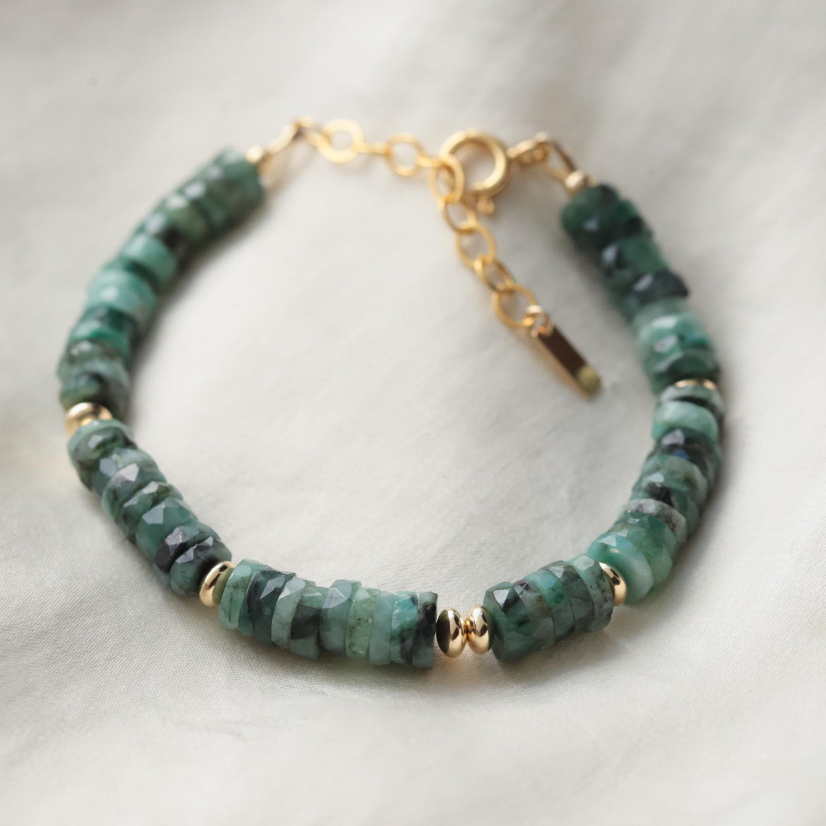 Earthly Abundance Earth Green Emerald bracelet showcasing vibrant green gemstones on a delicate silver chain.