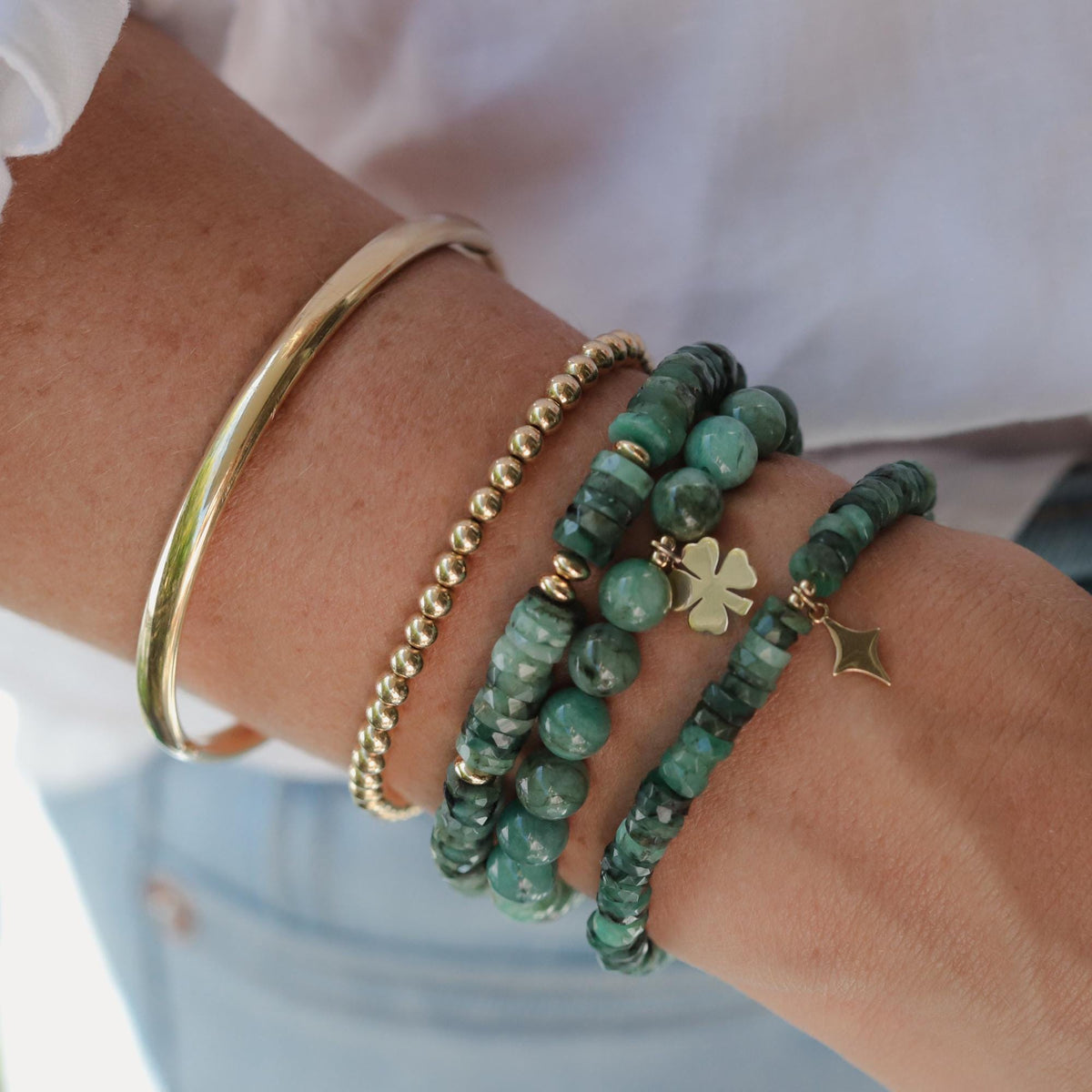 Earthly Abundance Earth Green Emerald bracelet featuring polished emerald beads on an elastic cord.