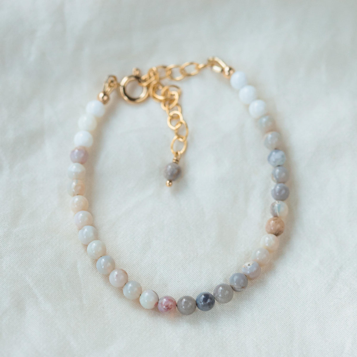Neutral opal bracelet with 14K gold-filled setting, featuring a delicate design and subtle gemstone display by Earthly Abundance.