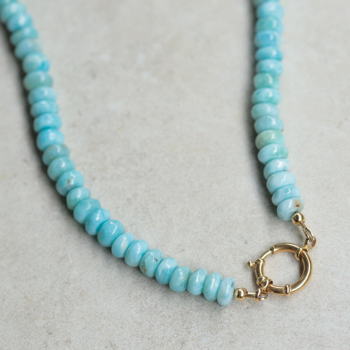 Tranquil Beauty Larimar pendant necklace with 14K gold chain from Earthly Abundance, showcasing a vibrant blue larimar gemstone.