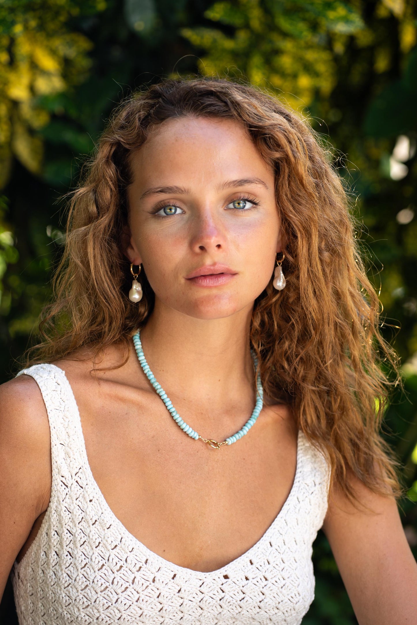 Tranquil Beauty Larimar necklace featuring a 14K gold chain and a smooth blue larimar pendant, crafted by Earthly Abundance.