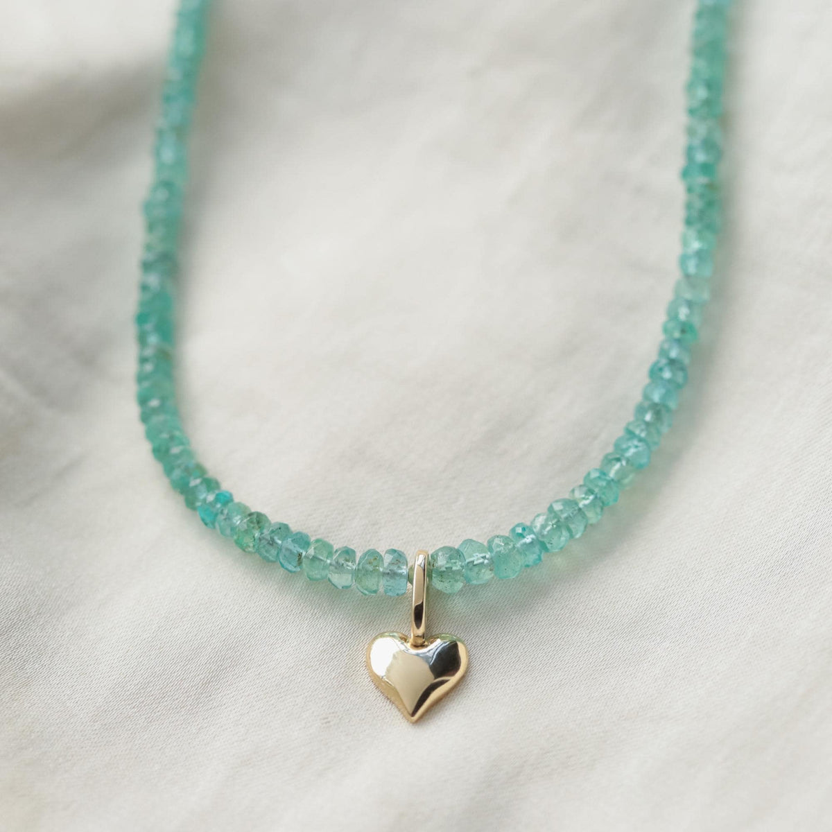Zambian emerald heart pendant necklace with sterling silver chain, featuring a vibrant green emerald heart gemstone.
