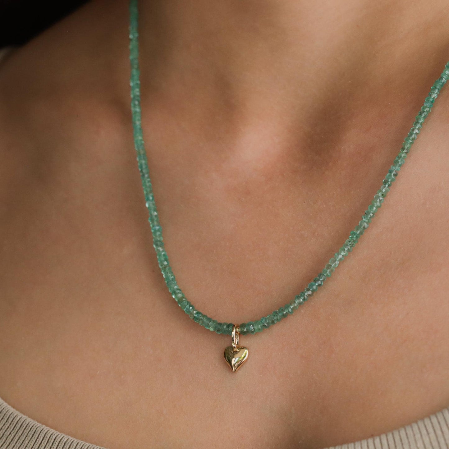 Zambian Emerald Heart Necklace featuring a vibrant green emerald pendant on a delicate chain, crafted by Earthly Abundance.