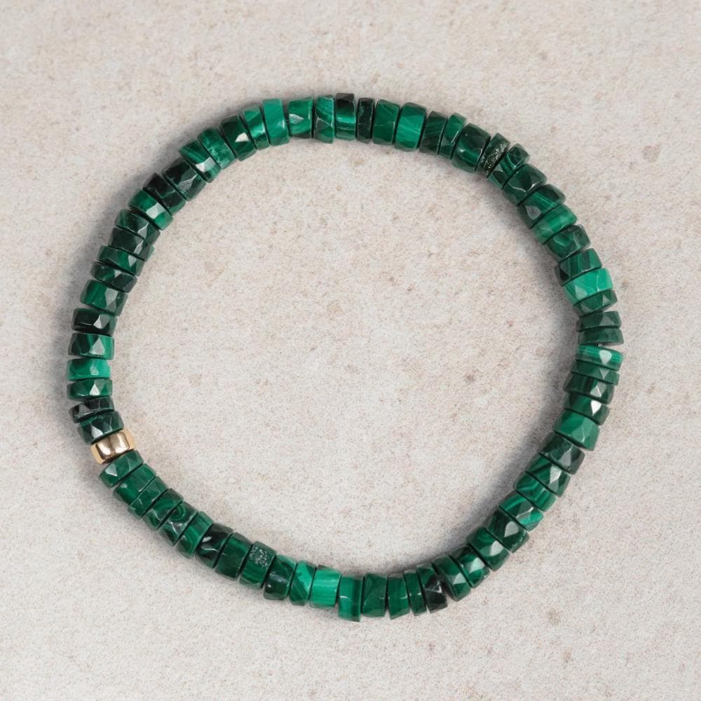 Earthly Abundance Malachite Heishi bracelet featuring small, polished green stone beads on a stretchy cord.