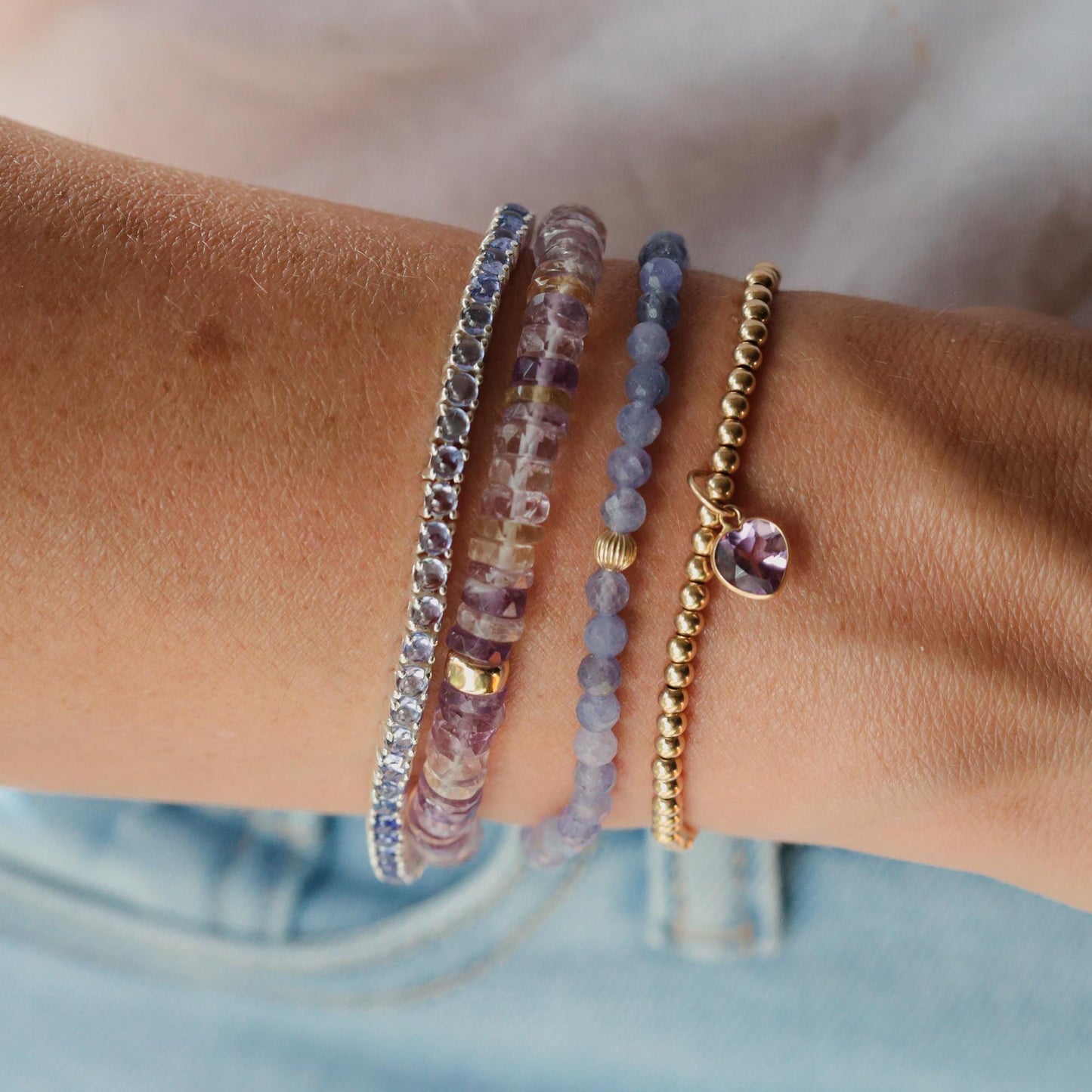 Ametrine and amethyst heart-shaped heishi beads bracelet by Earthly Abundance, featuring colorful gemstone accents on a delicate strand.