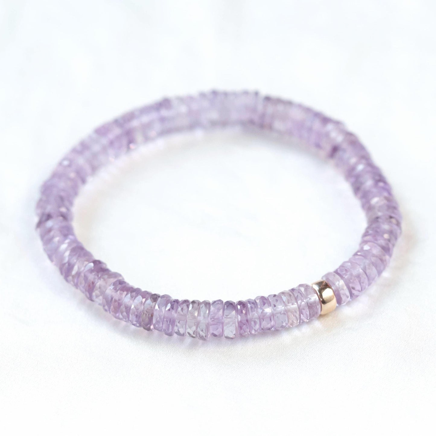 Ethereal pink amethyst heishi bracelet with small round pink beads, featuring a delicate and elegant jewelry design.