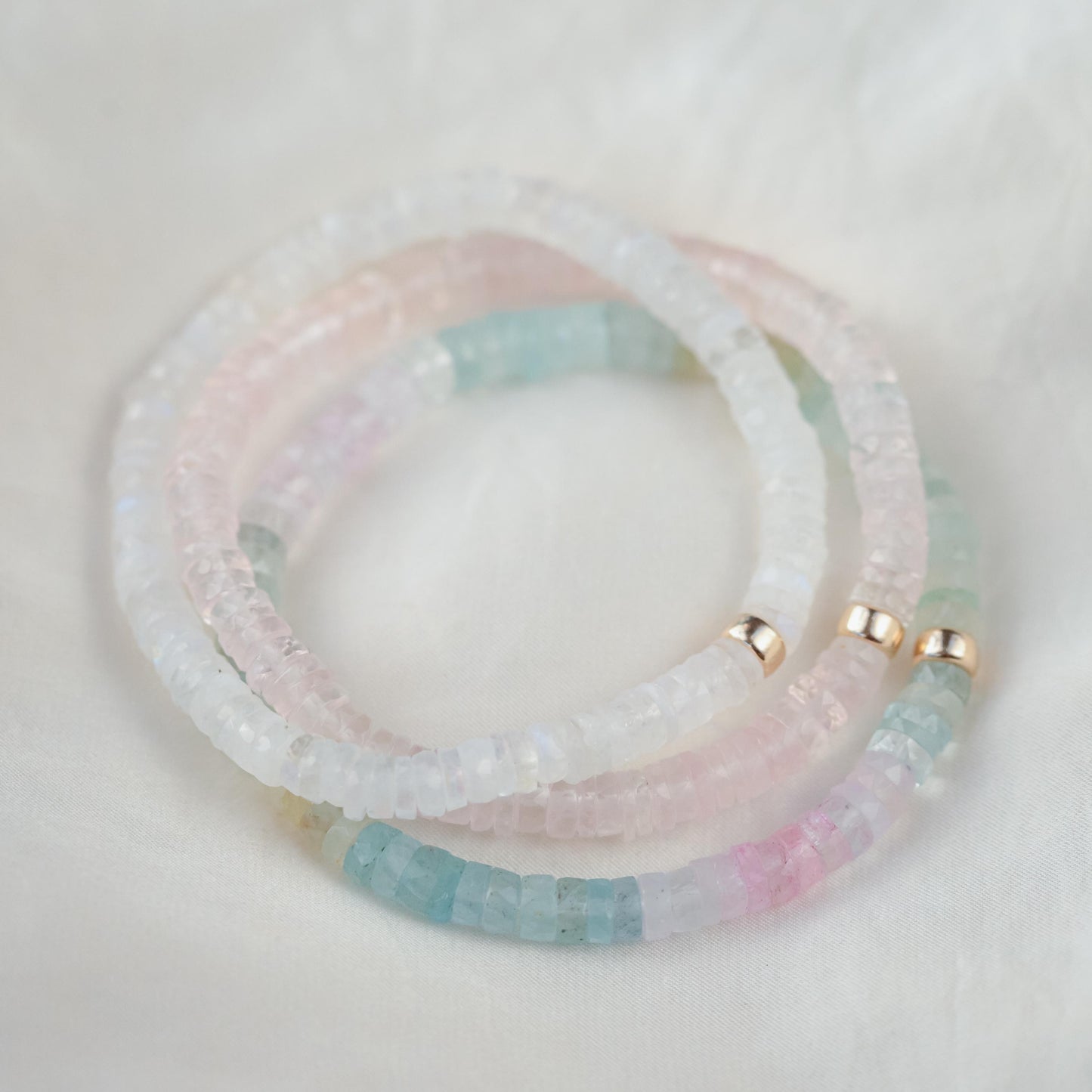 Rainbow Moonstone bracelet from Earthly Abundance featuring celestial-themed beads and a vibrant, iridescent rainbow glow.