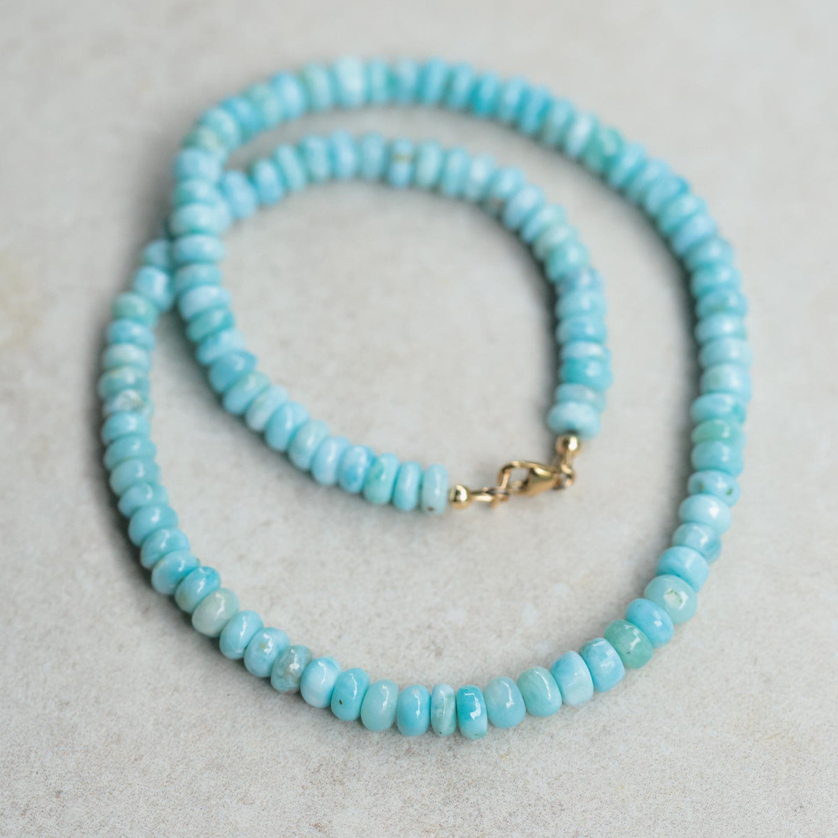 Dreamy Energy Larimar necklace with 14K gold setting, featuring a smooth, oval larimar gemstone on a delicate gold chain.