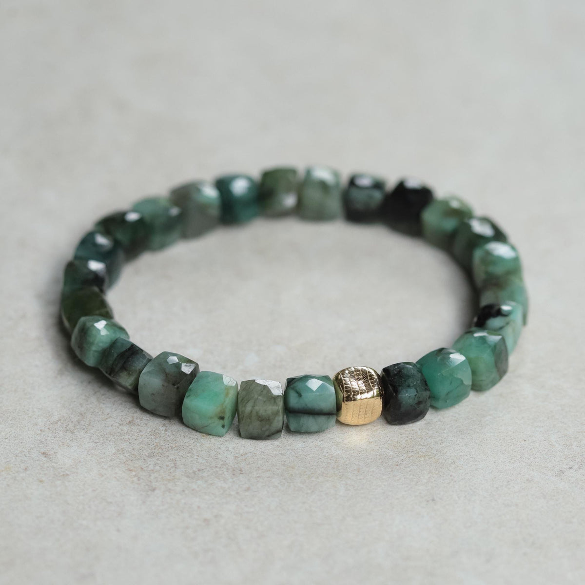 Emerald cube bracelet with 14K gold-filled chain from Earthly Abundance, showcasing square emerald beads on a delicate gold bracelet
