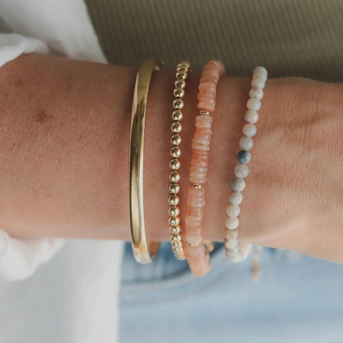 Neutral opal bracelet with 14K gold-filled chain from Earthly Abundance, showcasing a delicate, shimmering gemstone design.