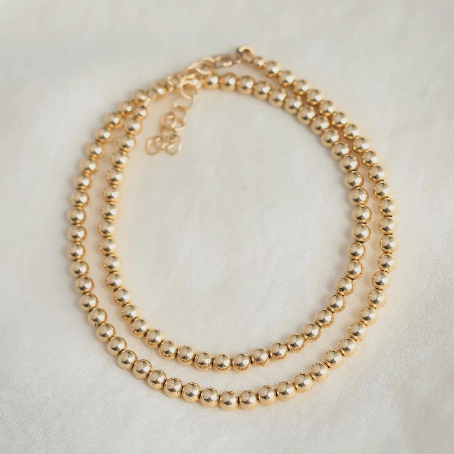 14k gold filled 4mm necklace from Earthly Abundance, close-up of the elegant chain with detailed link pattern.