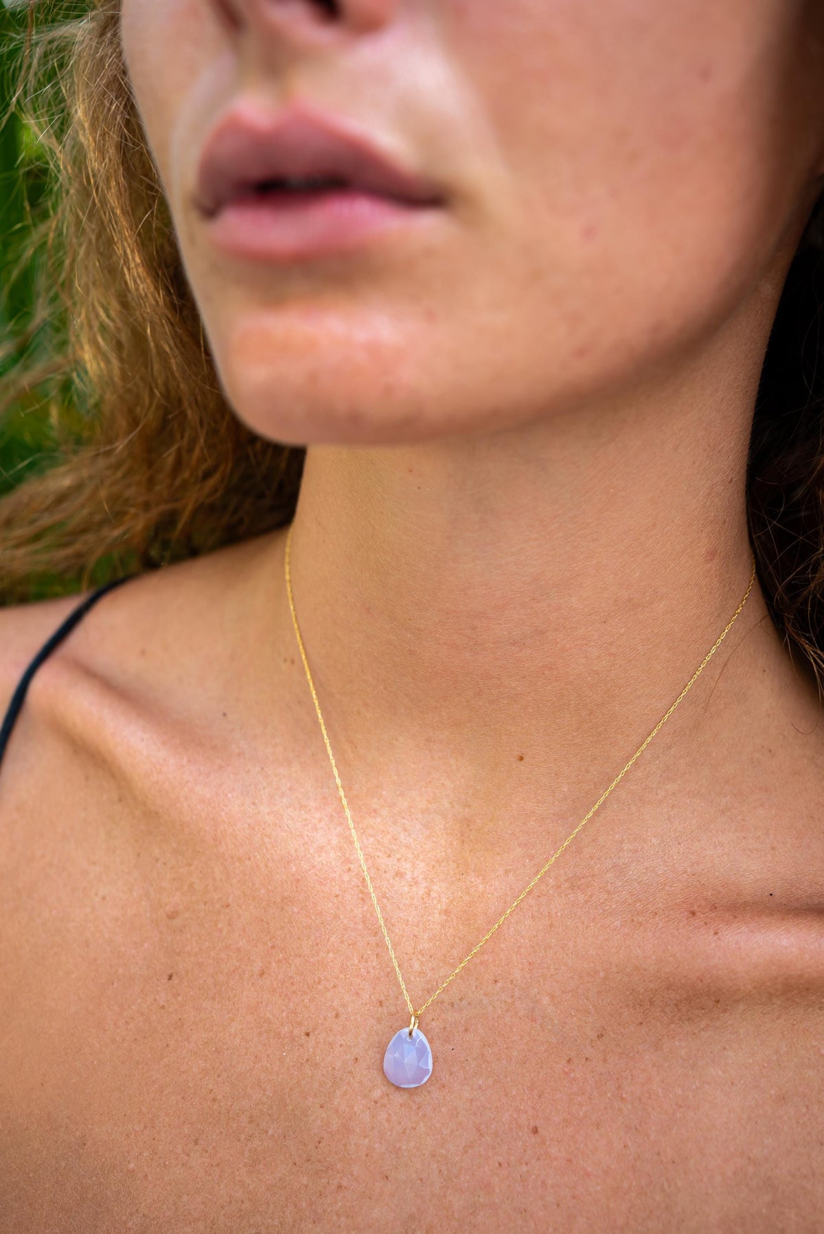 Lavender Blue Chalcedony pendant in 14K gold setting, showcasing a smooth, oval-shaped gemstone on a delicate chain.