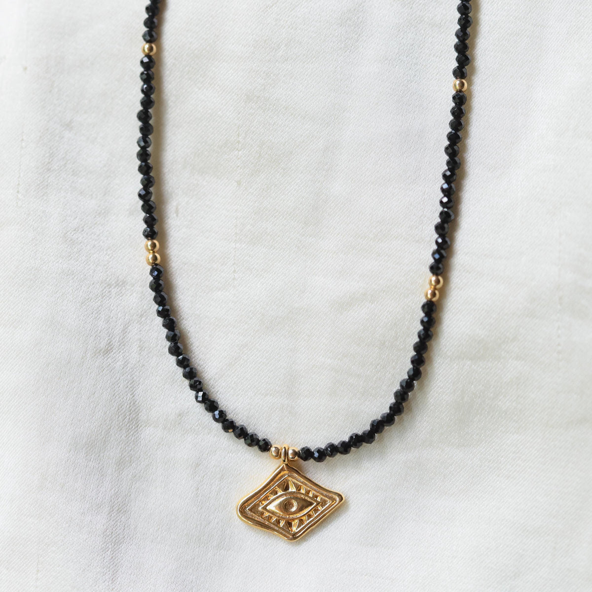Black Tourmaline necklace from Earthly Abundance featuring a polished black gemstone pendant on a delicate chain.