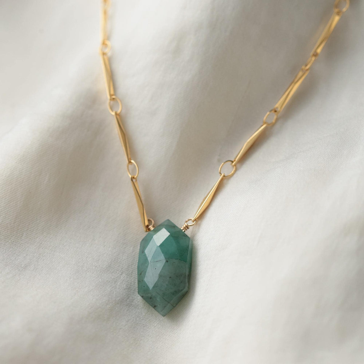 Elegant temple emerald necklace on a 14K gold-filled chain by Earthly Abundance, featuring a vibrant green gemstone pendant.
