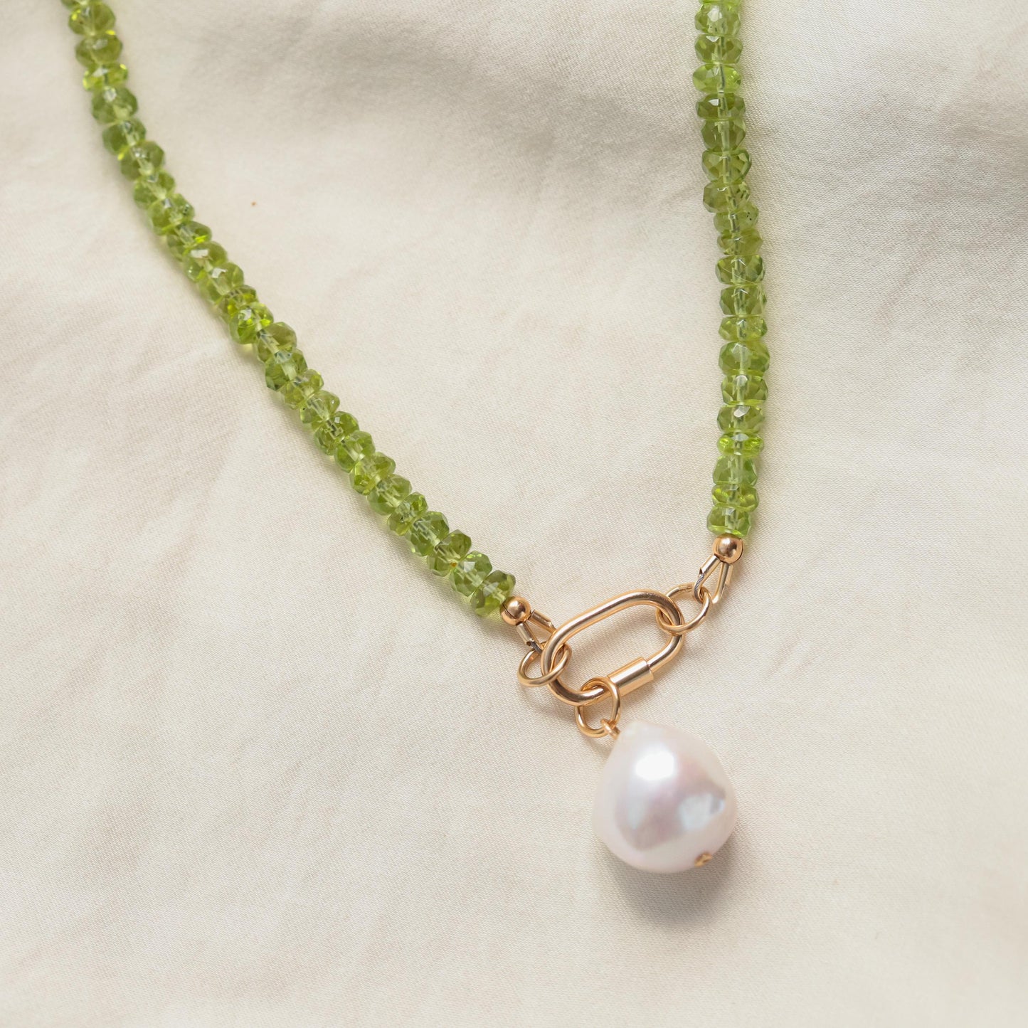 Peridot pearl carabiner necklace featuring green peridot stones and elegant pearl accents on a silver chain by Earthly Abundance