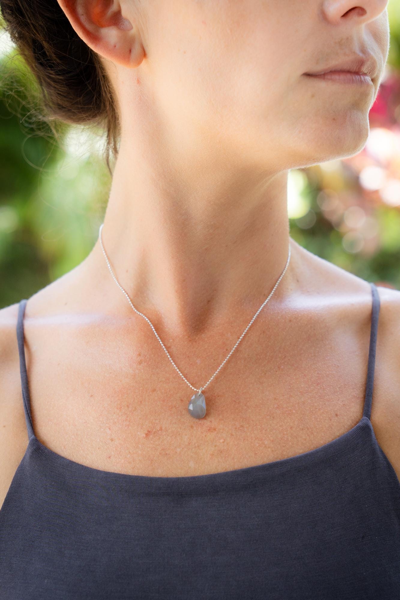 Grey moonstone necklace in sterling silver with a polished round moonstone pendant, showcasing a sleek, elegant jewelry design.