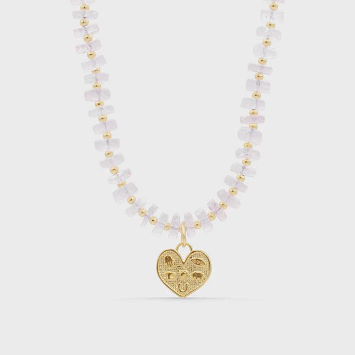 Lucky Heart Rose Quartz Necklace from Earthly Abundance featuring a polished pink quartz pendant on a delicate chain.