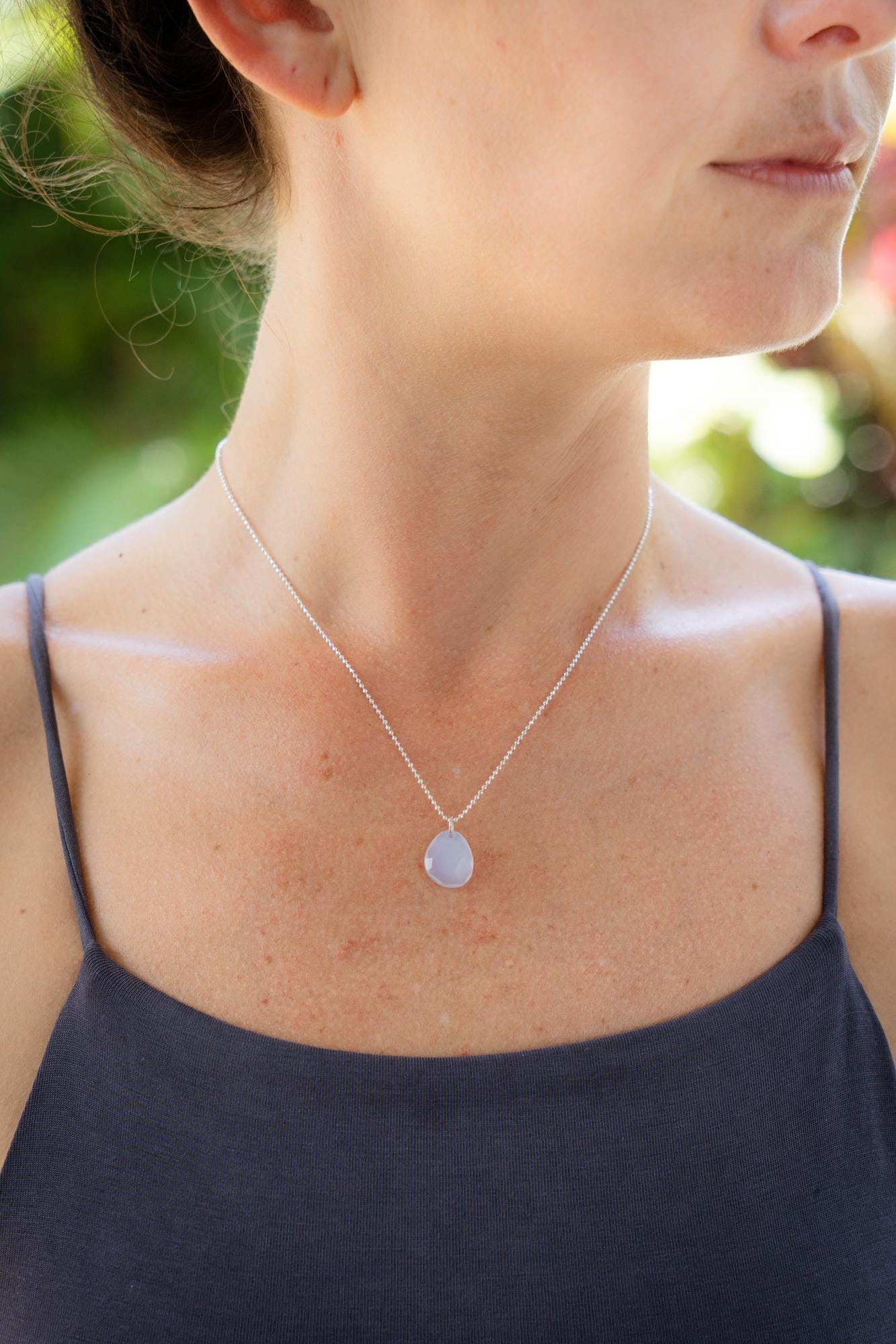 Lavender chalcedony necklace with sterling silver chain, featuring a polished lavender gemstone pendant.