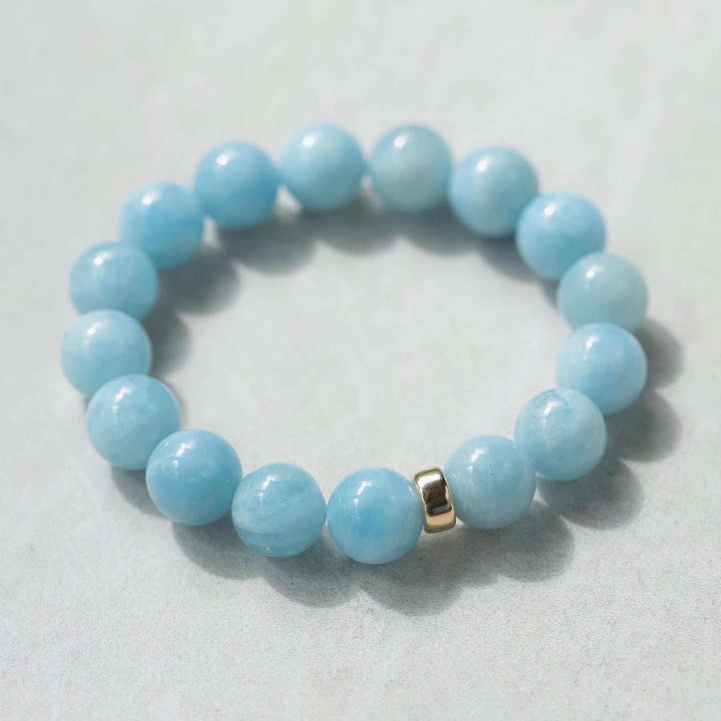 Earthly Abundance Rock Candy Aquamarine bracelet with 12mm beads, showcasing vibrant blue gemstone jewelry.