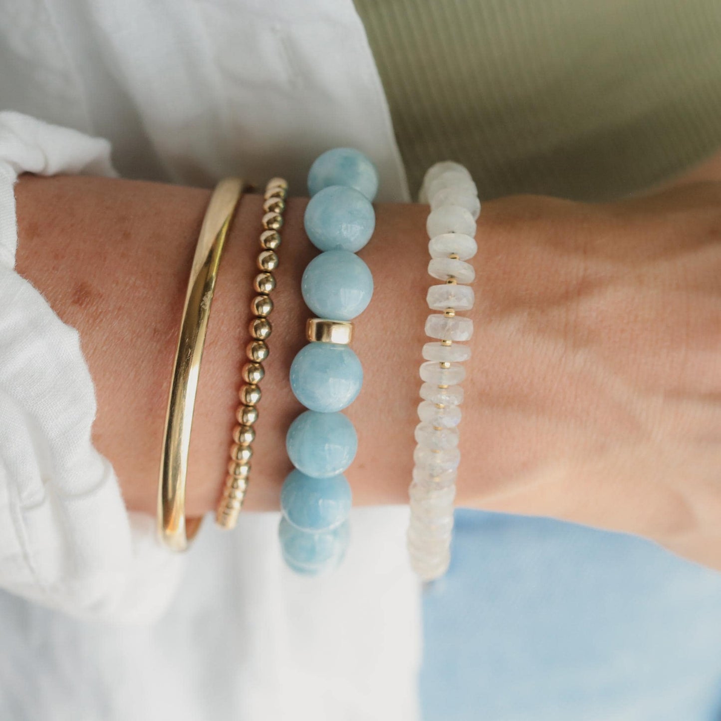 Earthly Abundance aquamarine bracelet with 12mm round beads, featuring vibrant blue-green stones on a delicate jewelry strand.