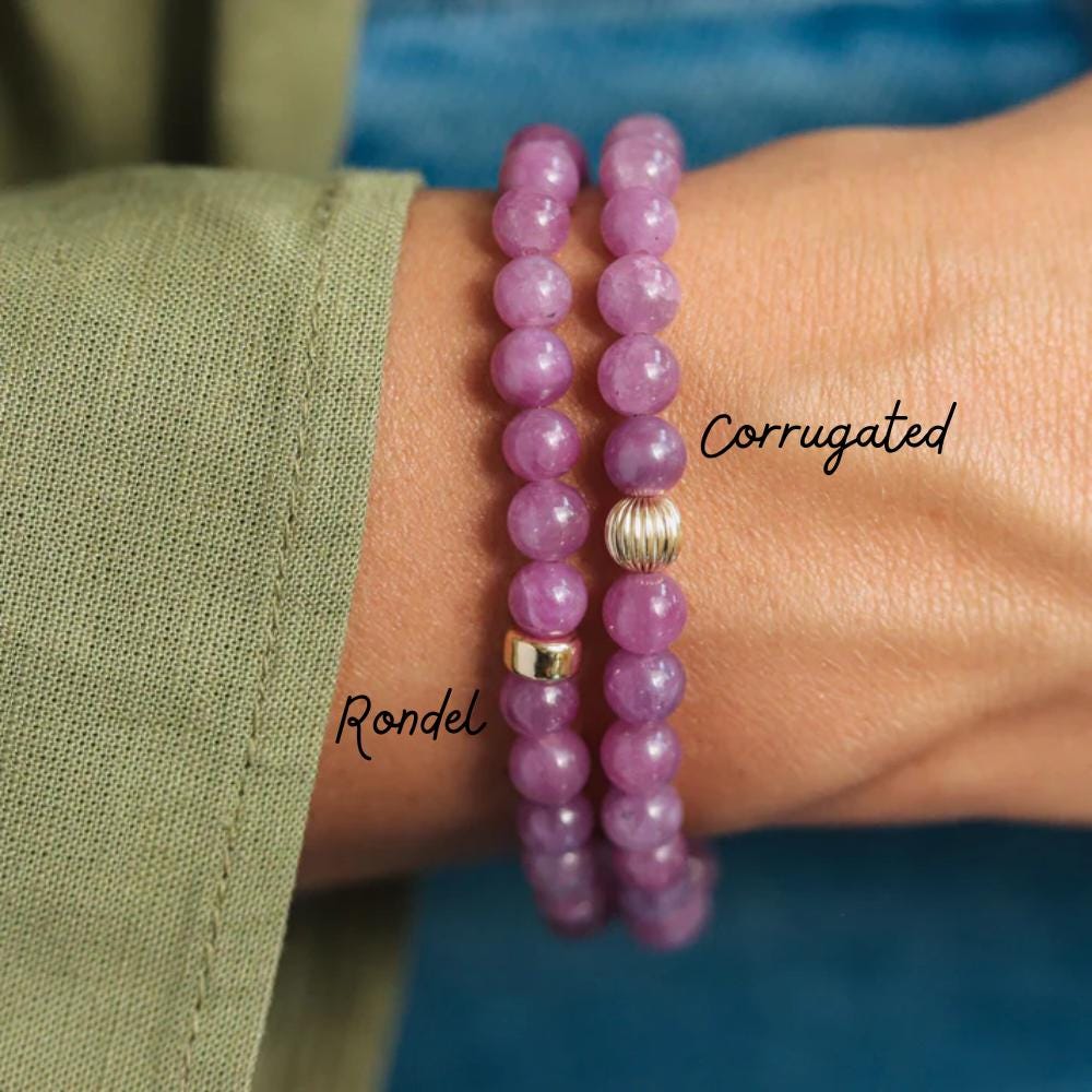 Earthly Abundance Gemma Ruby Bracelet featuring vibrant red rubies on a delicate silver chain, close-up view of the jewelry.