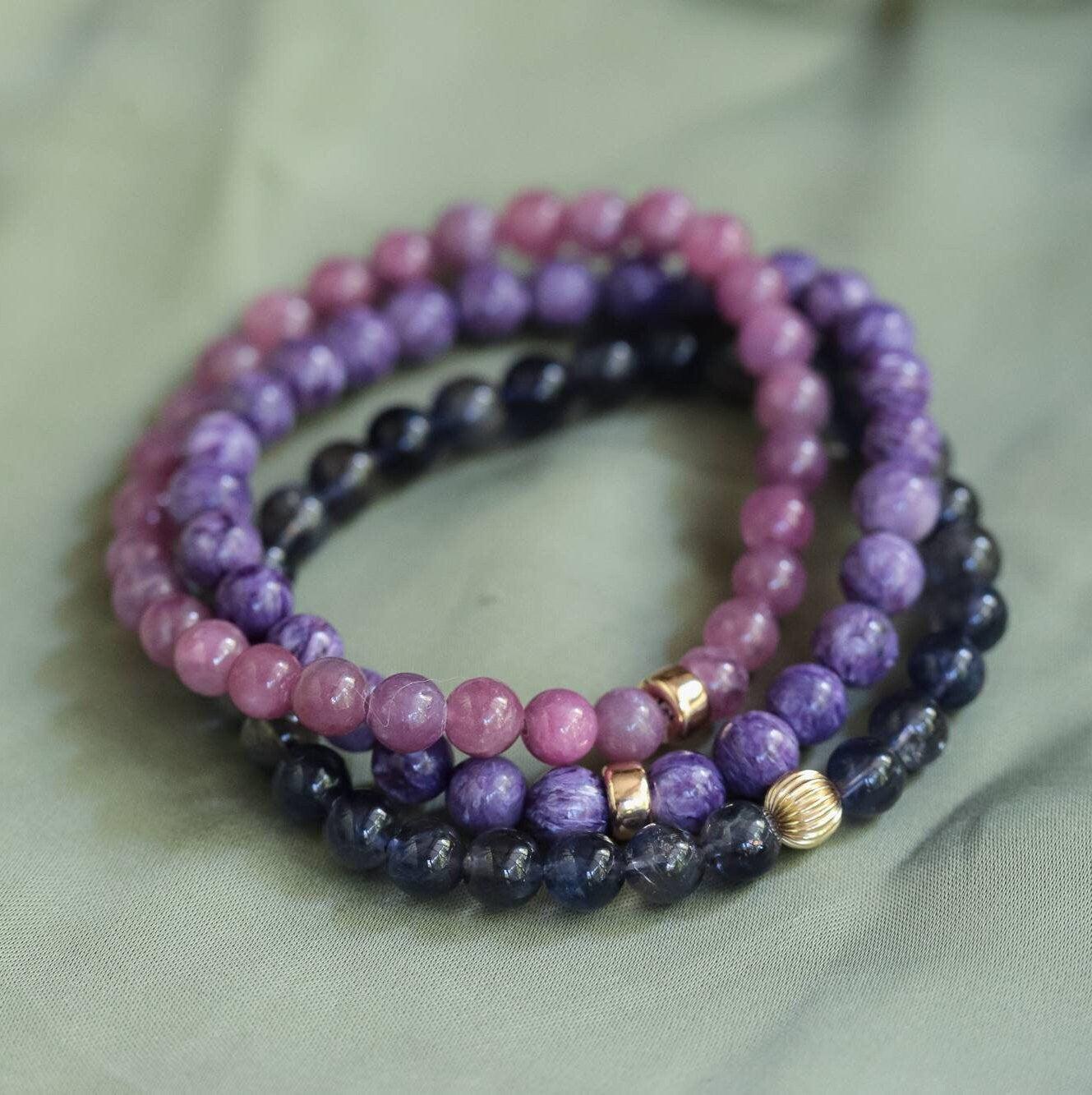 Earthly Abundance Gemma Ruby Bracelet with polished red ruby beads and silver clasp, displayed on a neutral background.