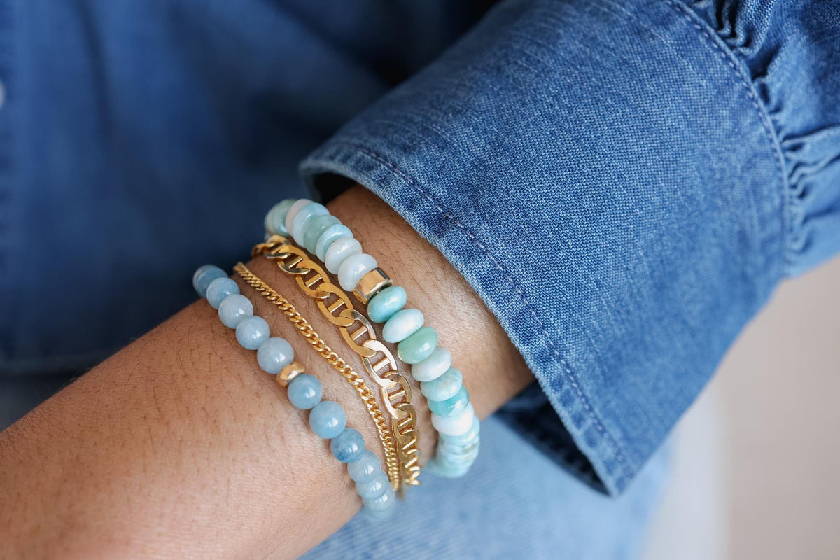 Larimar rondel bracelet featuring blue gemstone beads from Earthly Abundance, displayed on a neutral background.