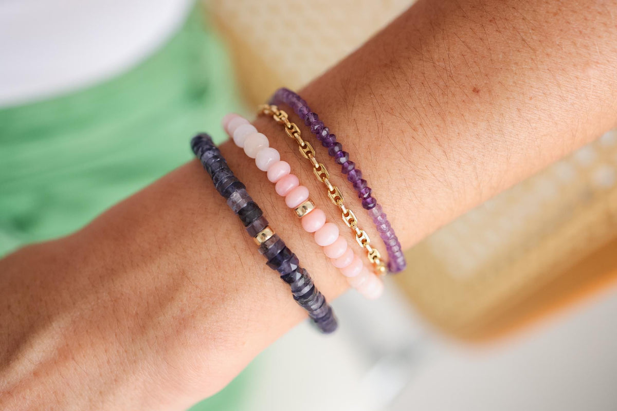 Iolite Heishi bracelet with 5mm round beads from Earthly Abundance, featuring alternating blue and gray tones on a white background.