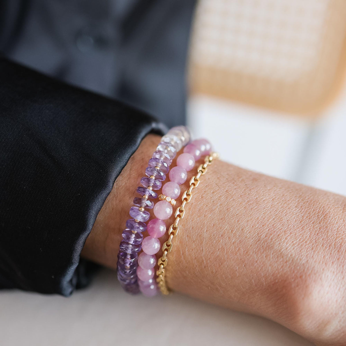 Amethyst Heishi ombre bracelet by Earthly Abundance featuring small purple and white beads on a stretch cord.