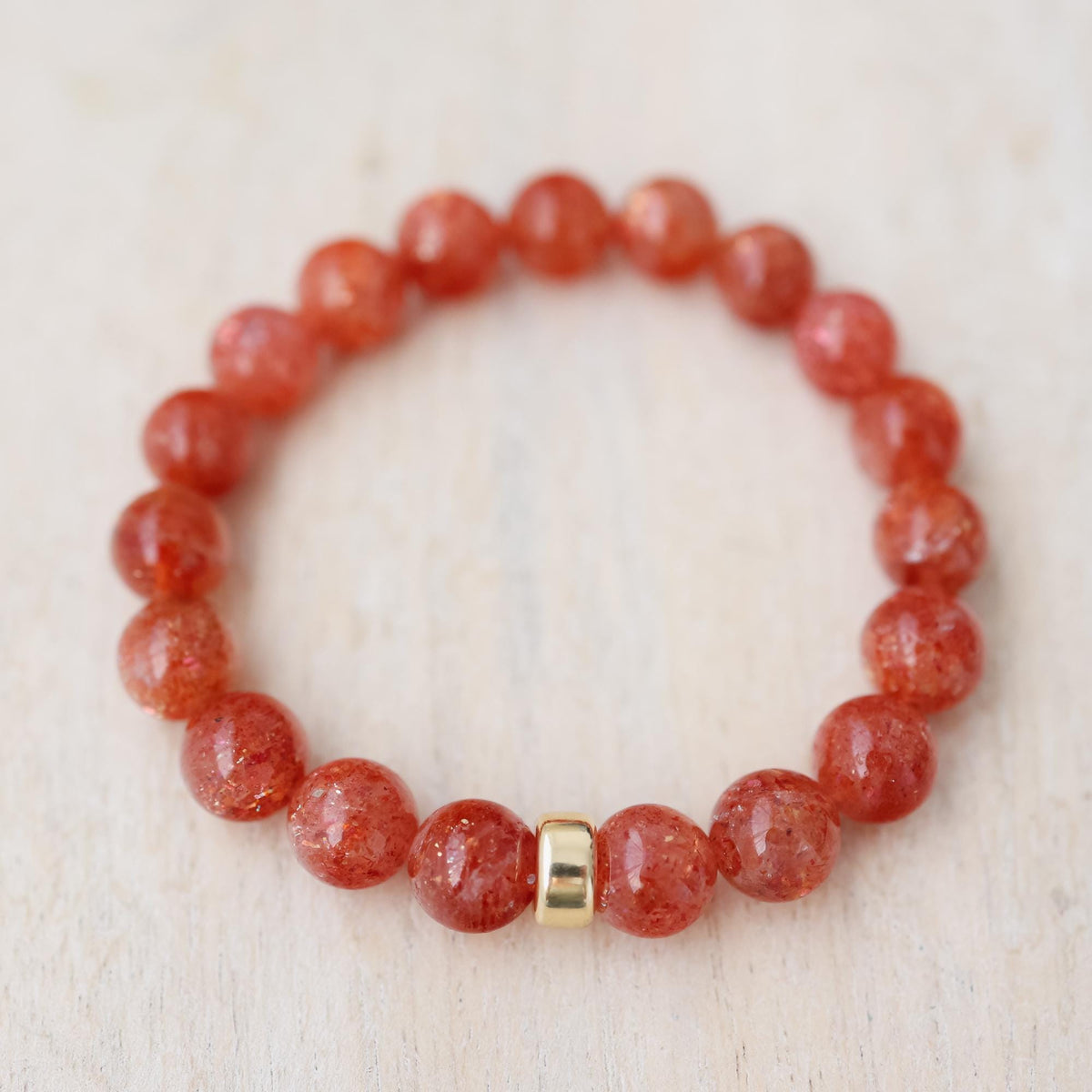 Golden Ember Sunstone bracelet with 14K gold accents from Earthly Abundance, featuring warm, shimmering sunstone beads.