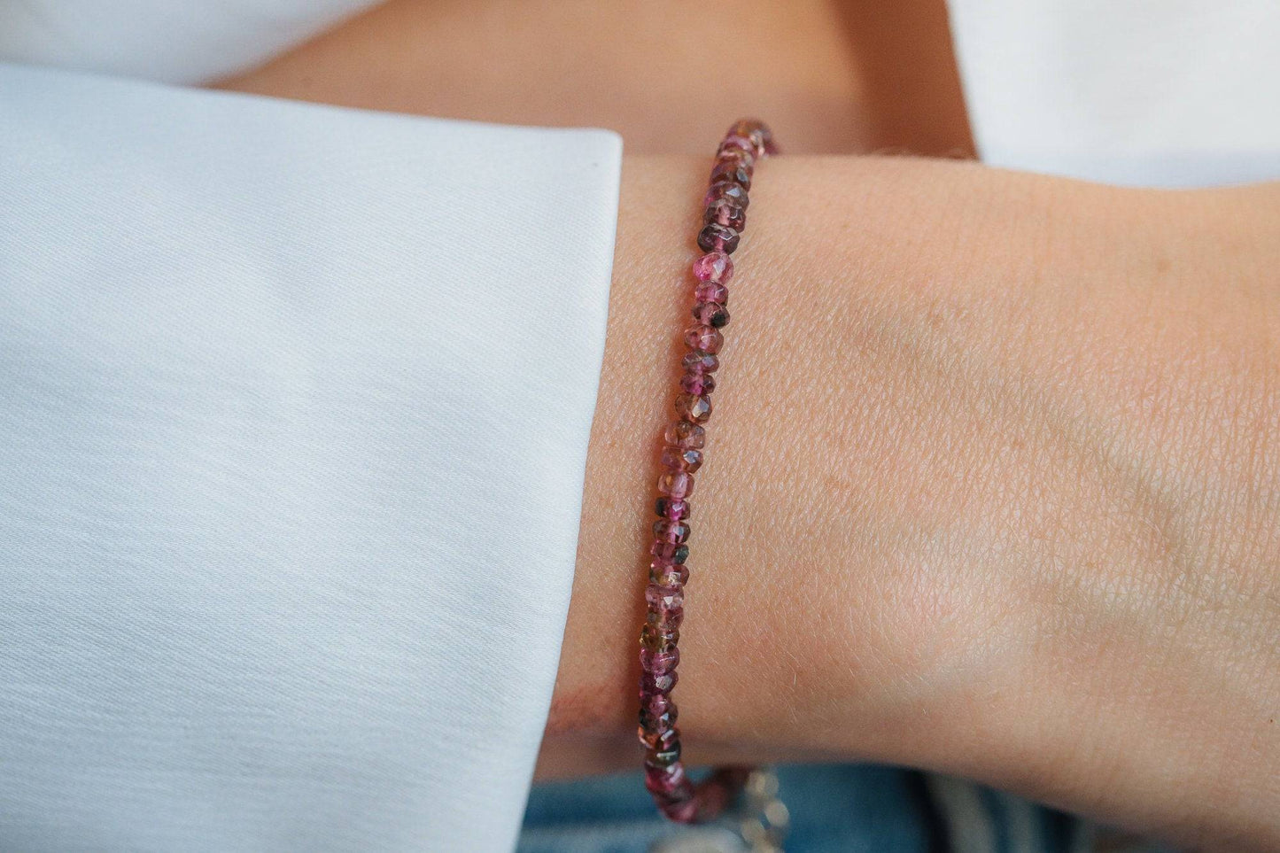 Mini tourmaline bracelet from Earthly Abundance Jewelry featuring colorful, polished gemstone beads on an elastic band.