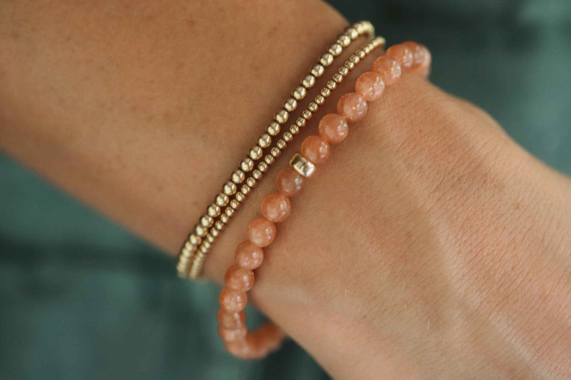 a beaded bracelet with a gold clasp