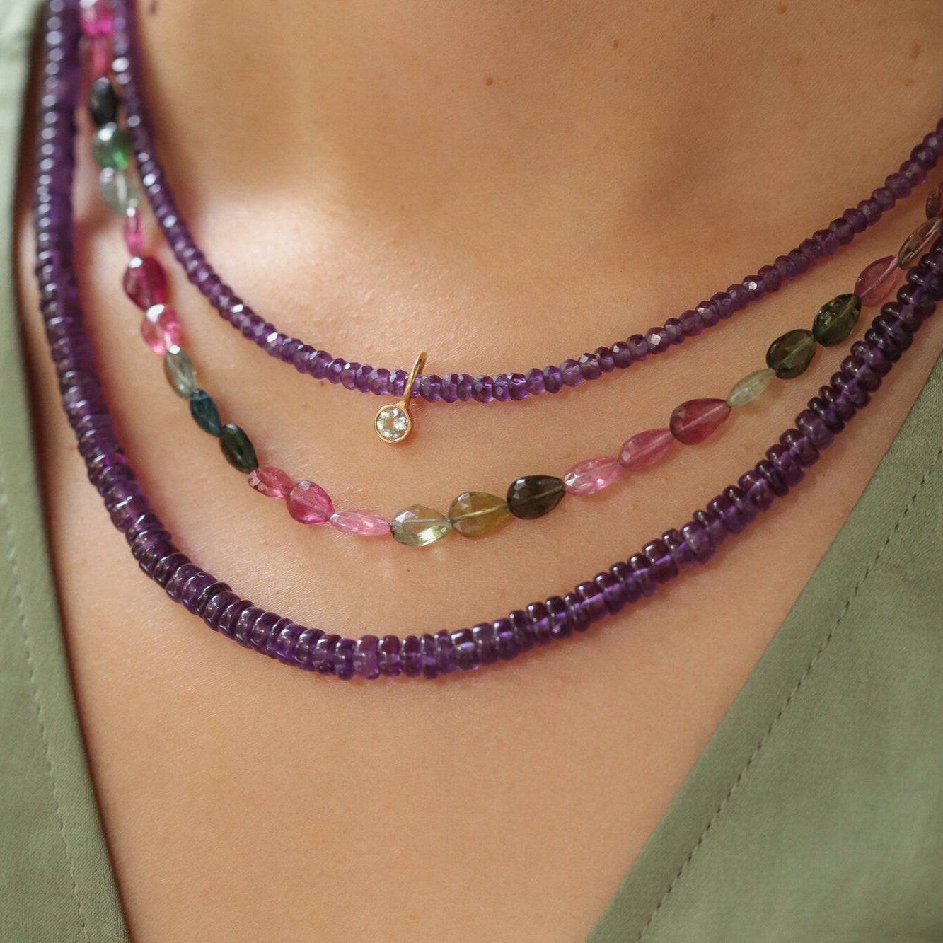 Mixed tourmaline pear-shaped necklace featuring multicolored gemstones from Earthly Abundance, displayed on a white background.