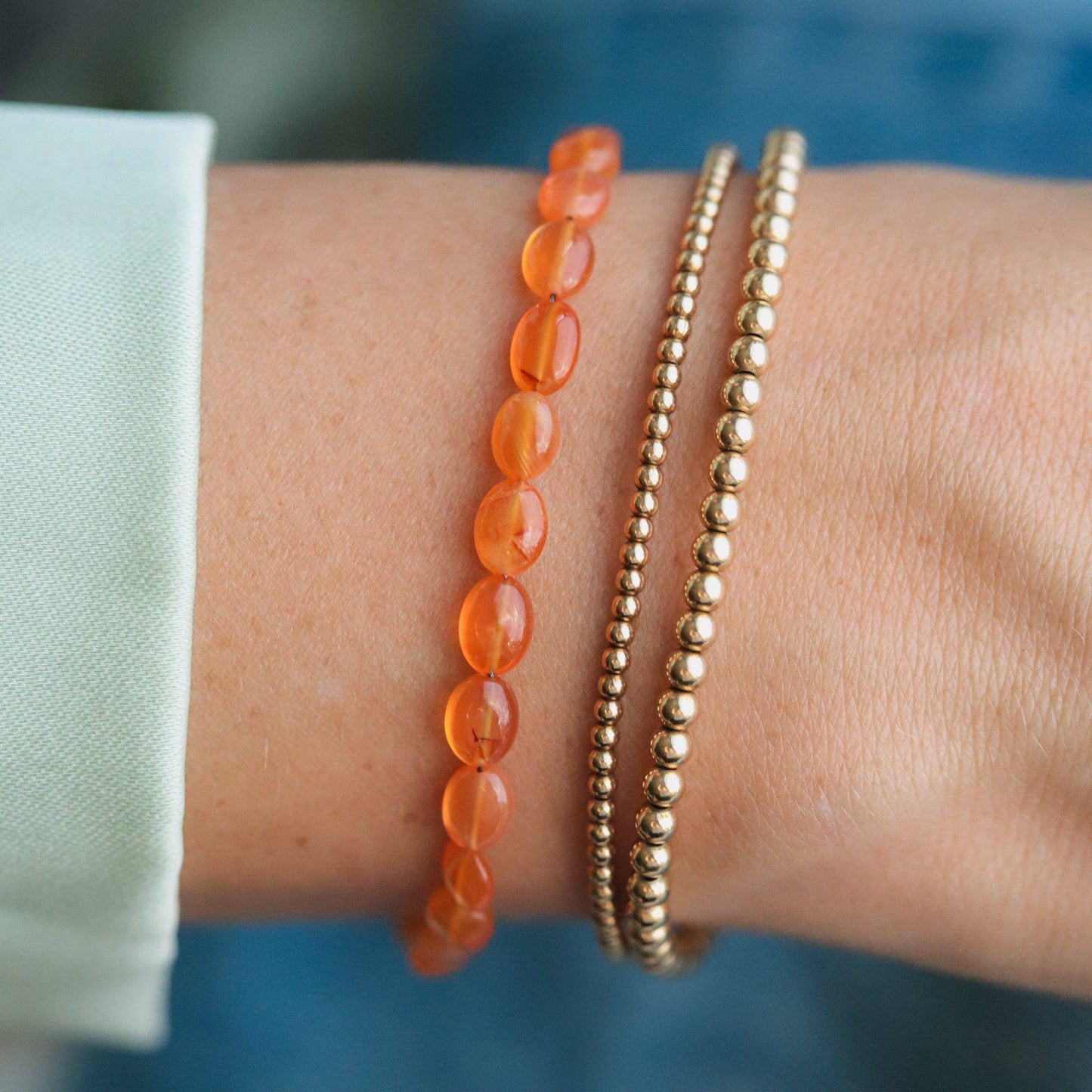 Earthly Abundance Carnelian nugget bracelet featuring polished orange-red stones on an elastic band.