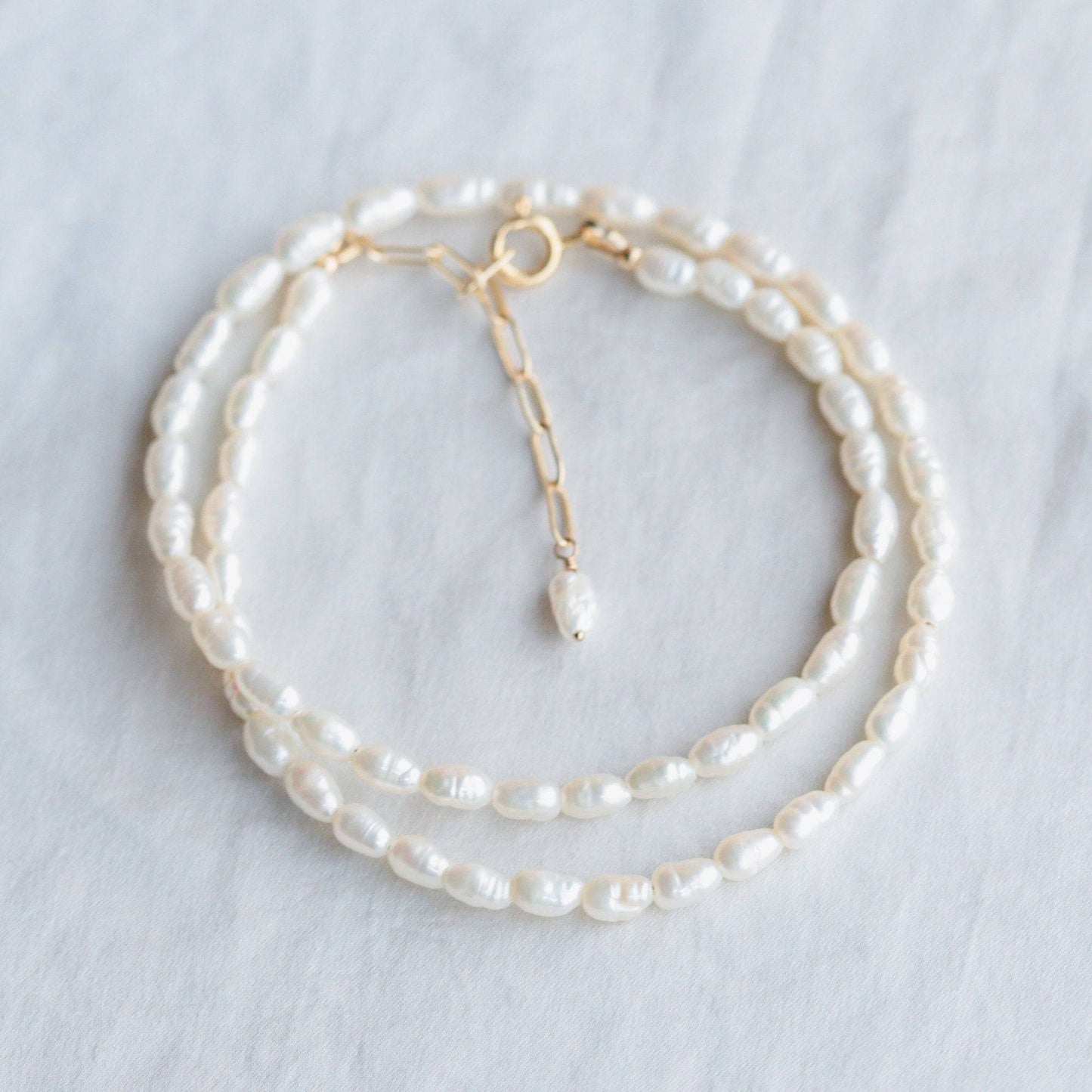 Gold-filled Rice Pearl necklace by Earthly Abundance featuring small, lustrous white pearls on a delicate chain.