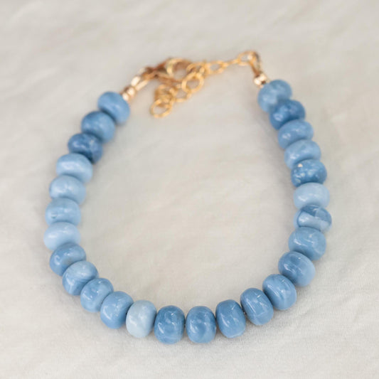 Blue Opal bracelet by Earthly Abundance featuring polished blue opal beads on a delicate elastic cord.