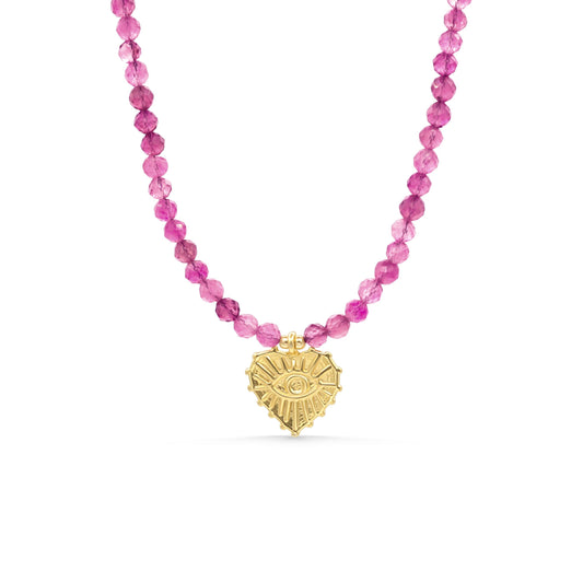 Pink tourmaline evil eye heart pendant from Earthly Abundance, featuring a vibrant pink gemstone in a heart shape with protective evil eye design.