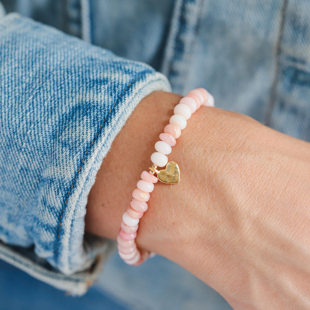 Pink Opal heart bracelet by Earthly Abundance featuring a delicate pink gemstone heart charm and adjustable cord.