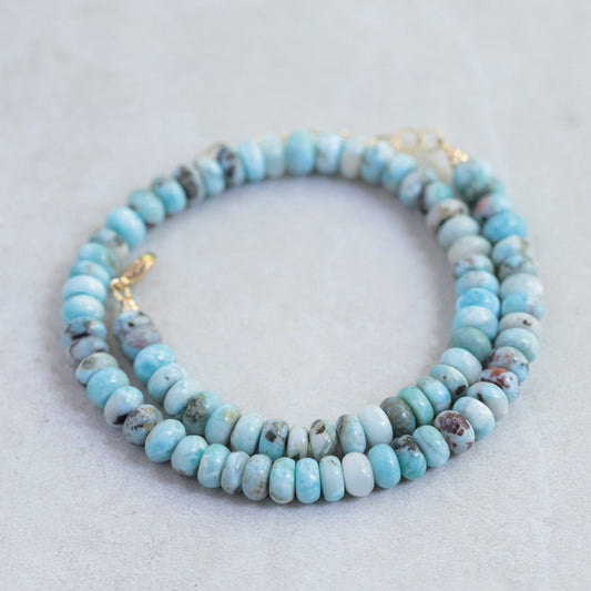 Candy Larimar necklace featuring a polished blue larimar pendant on a silver chain, displayed against a neutral background.